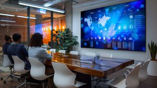 People watching a Philips display powered by a Q-Sys plug-in in a conference room.