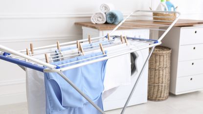 Clothes drying on rack in white room
