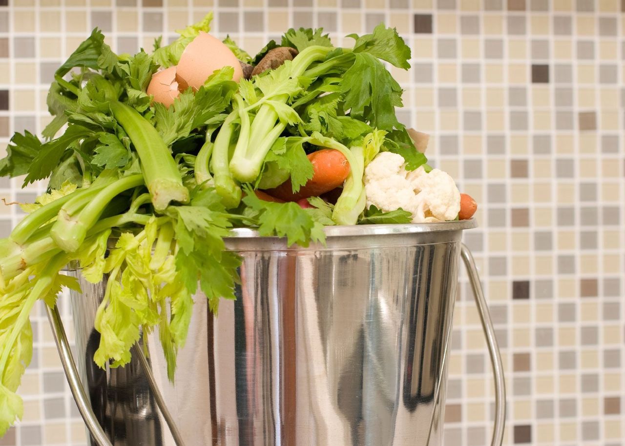 Silver Bucket In Kitchen Filled With Compost Foods