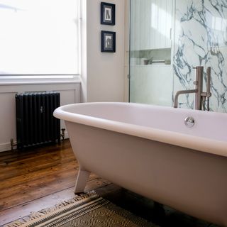 bathroom with bathtub and glass door