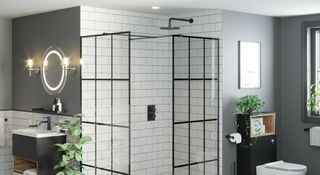 Black framed shower screen in a Crittall style with white metro tiles and matt black shower head