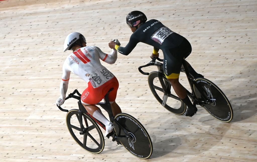 Polands Patryk Rajkowski L congratulates Malaysias Muhammad Shah Firdaus Sahrom after Sahrom won a heat of the mens track cycling sprint 116 finals repechages which was rerun after Rajkowski crashed during the Tokyo 2020 Olympic Games at Izu Velodrome in Izu Japan on August 4 2021 Photo by Greg Baker AFP Photo by GREG BAKERAFP via Getty Images