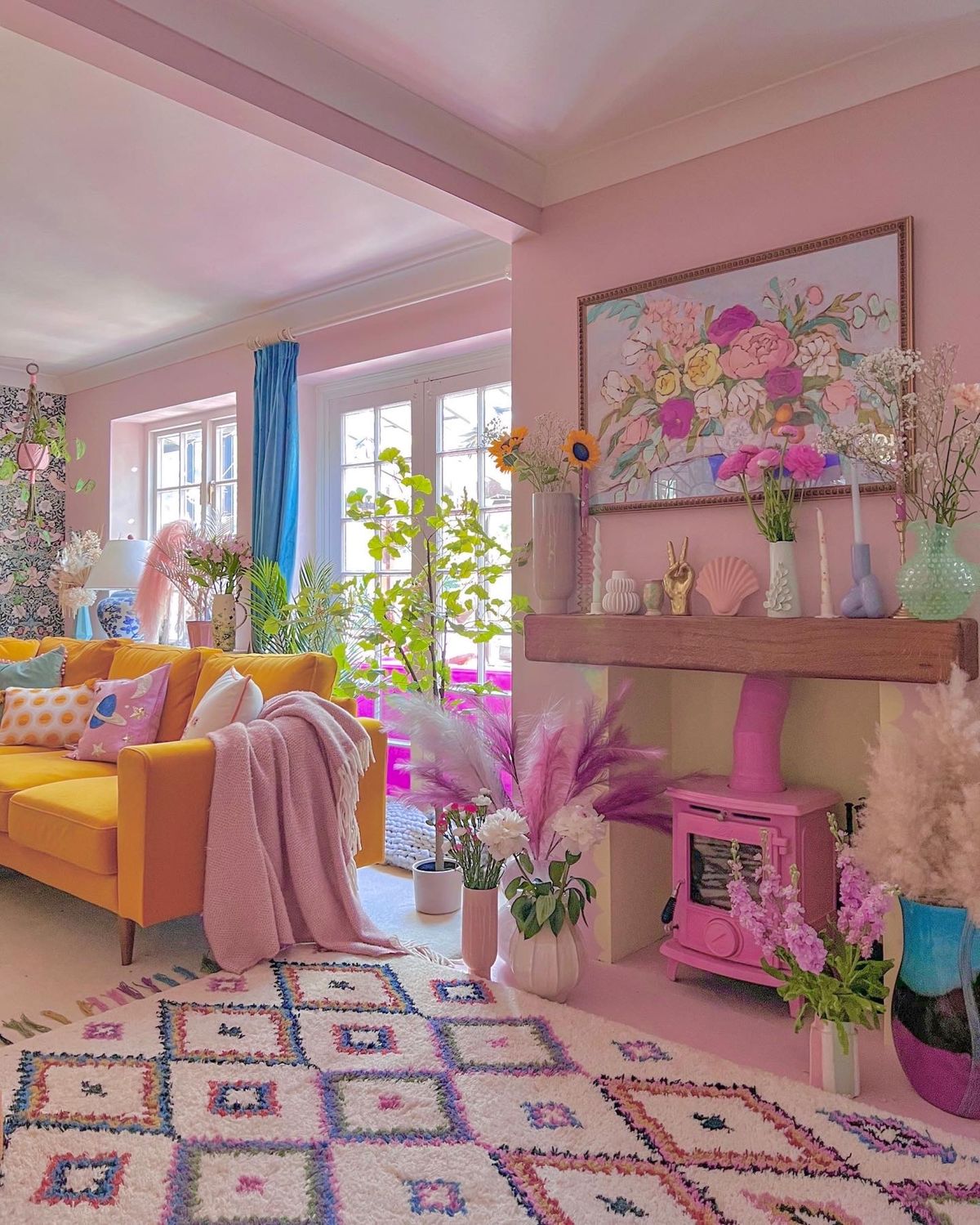 Dining/living room with fireplace given pink makeover