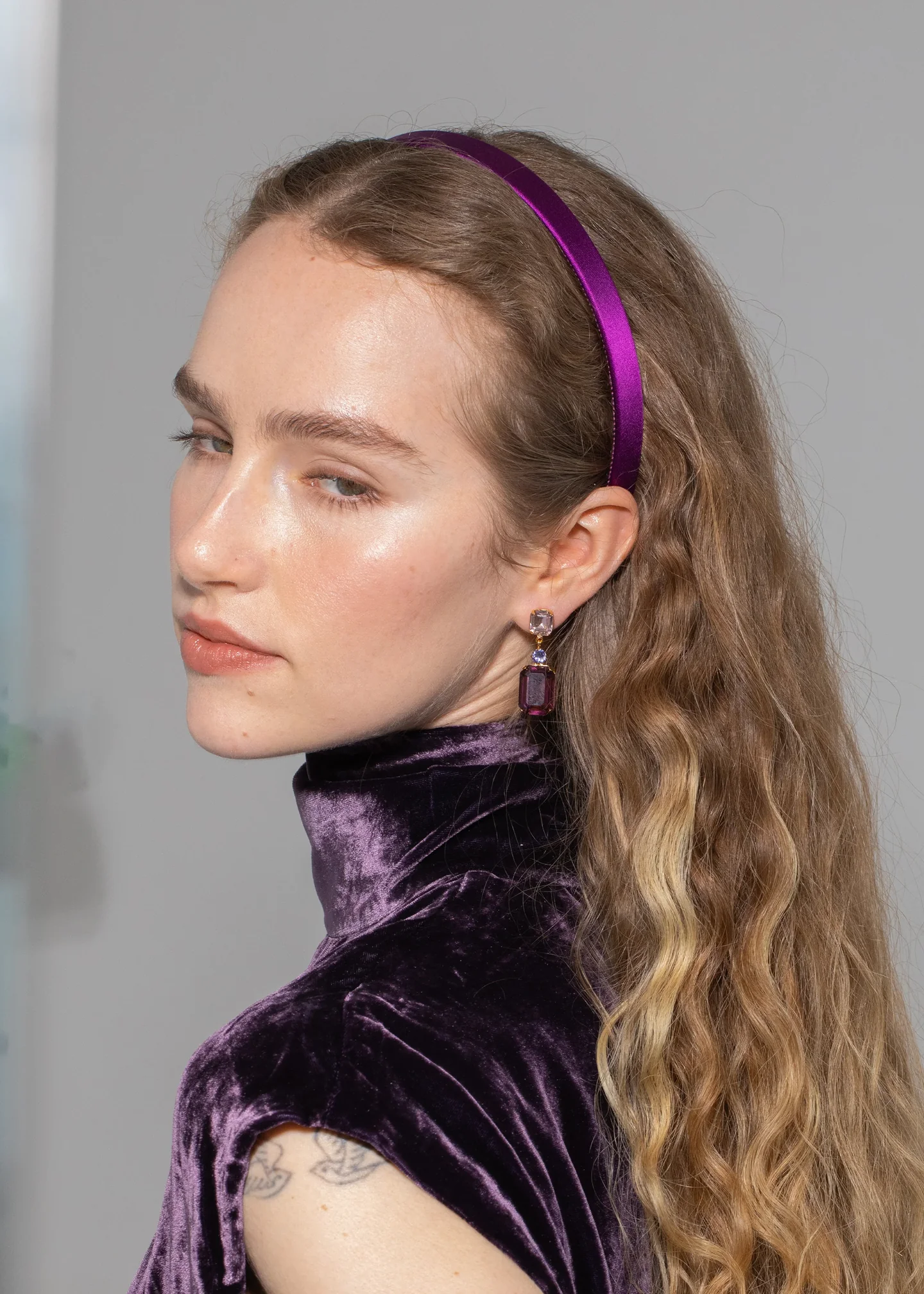 A woman wearing a purple headband.