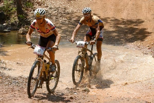 Christoph Sokoll and Kevin Hulsmans (Darrell Lee-Donckers Koffie Cycling 1) through a water crossing