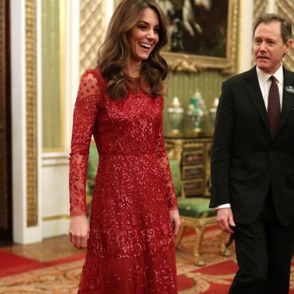 Catherine, Duchess of Cambridge walks through to the State Room with the Master of the Household during a reception to mark the UK-Africa Investment Summit at Buckingham Palace on January 20, 2020 in London, England