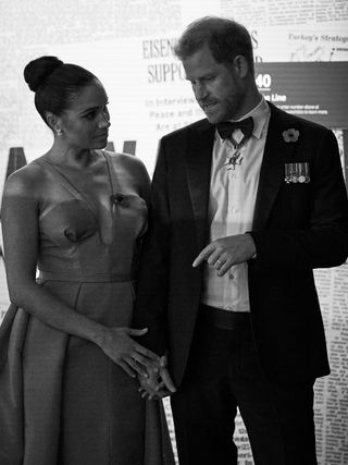 Black and white shot of Prince Harry and Meghan Markle at a gala