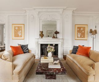 living room original moldings and fireplace cream sofas