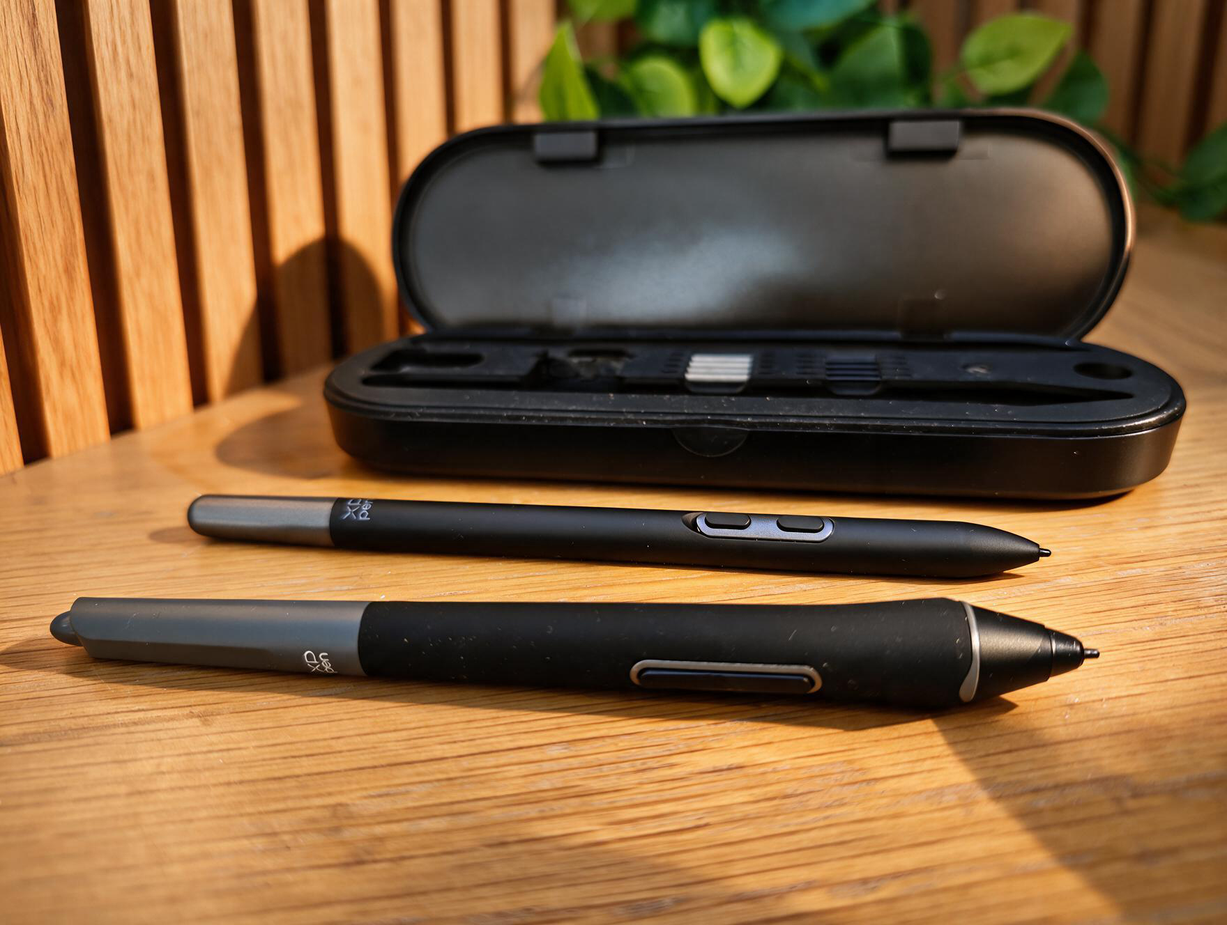 A black stylus on a wooden table