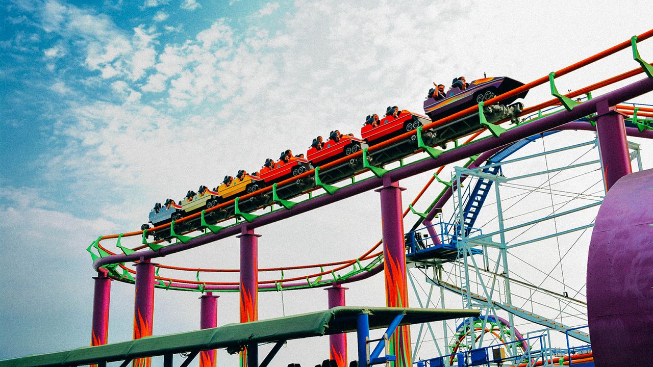 people on a roller coaster in one of the best theme parks in Orlando