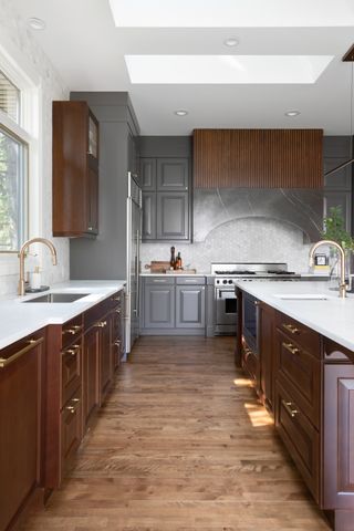A kitchen in all wood with quartz countertops