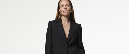 Model wearing a black blazer and gold earrings sold at Hobbs