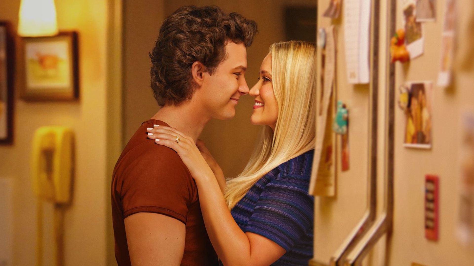 Georgie and Mandy embrace by a fridge