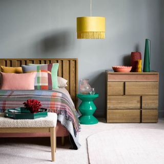 bedroom paint ideas, grey bedroom with bright accessories and matching wood bed and side table, bright yellow pendant light