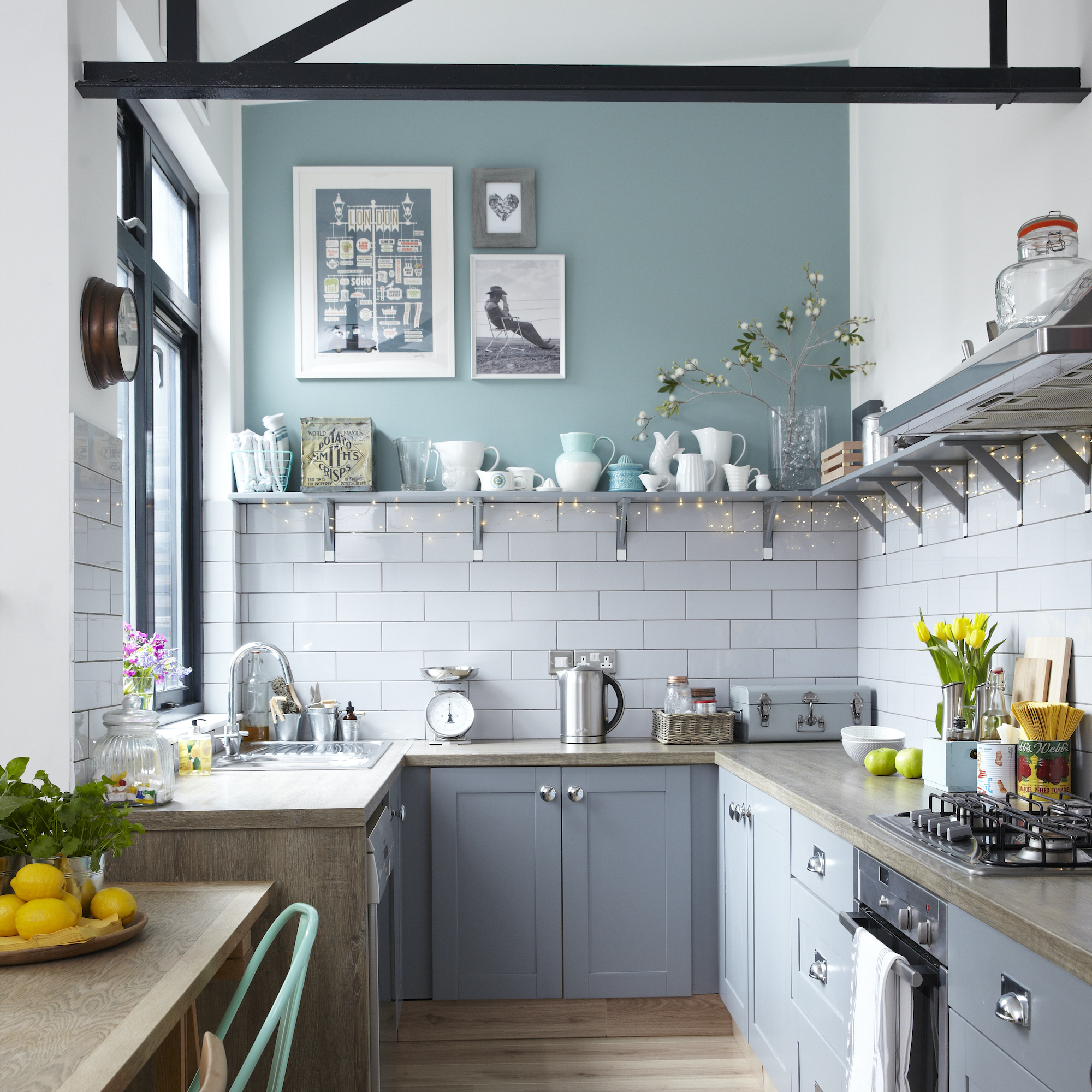 kitchen with grey cabinets and fairy lights under the shelving