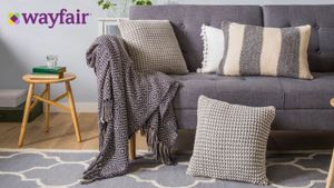 Wayfair lifestyle image of grey sofa with cushions and throw, wayfair logo in top left corner