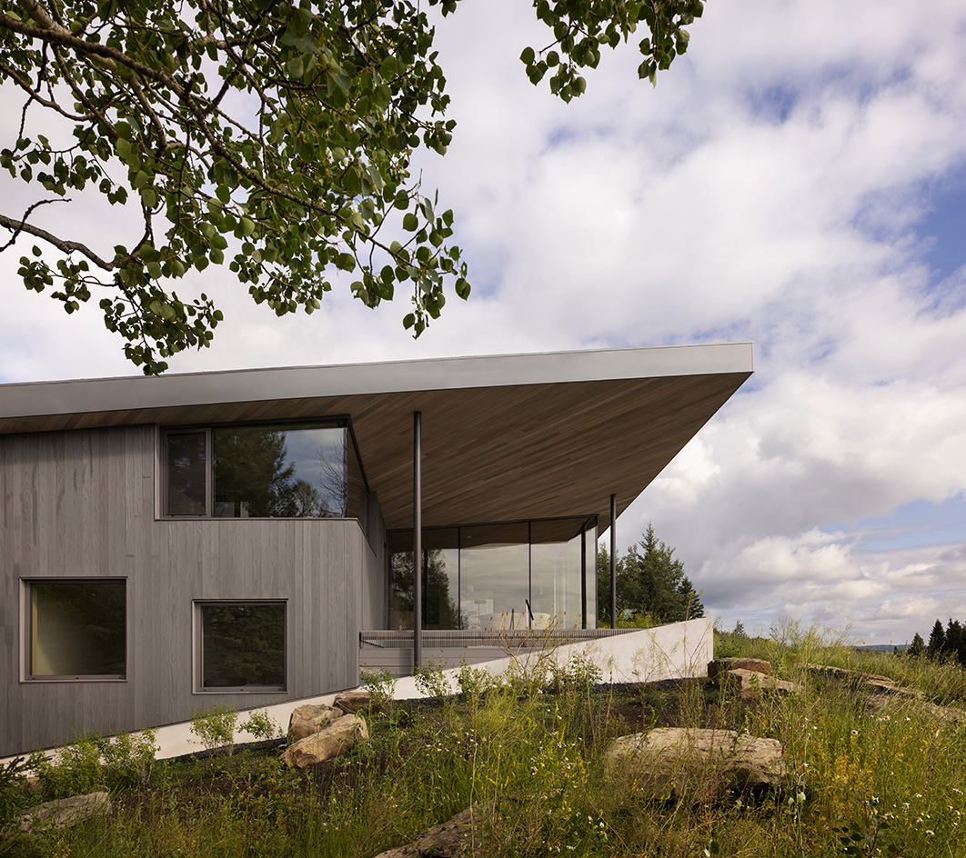 Cut Out House, a square footprint home with a round cut out set in the canadian winderness, by a lake
