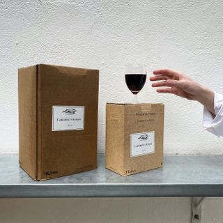 Cardboard boxes with a glass of red wine on top