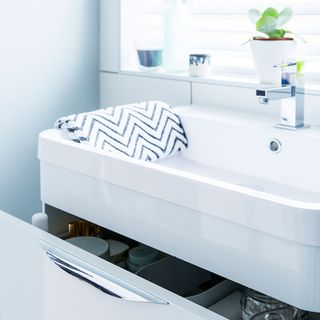 bathroom with white wall and white sink