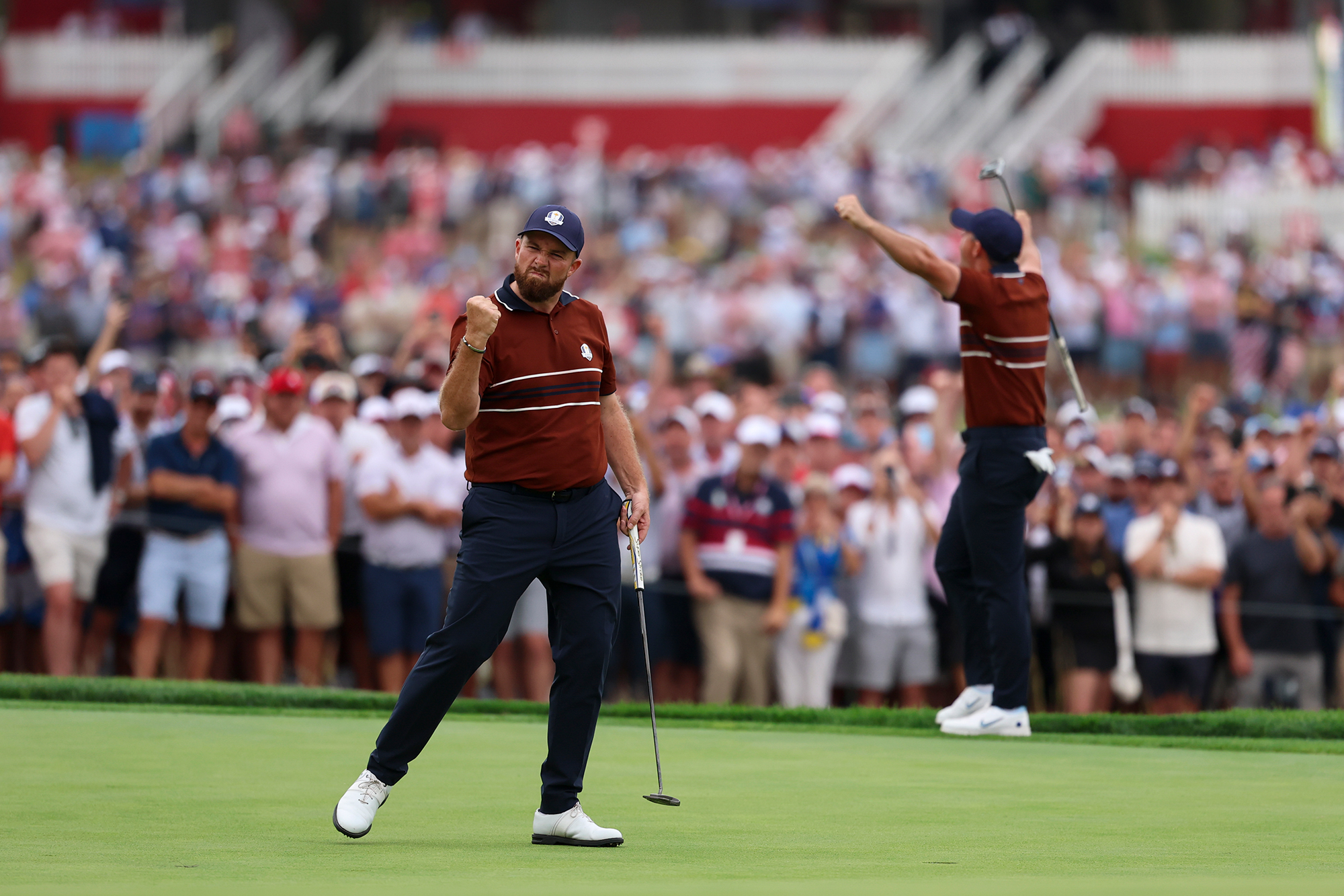 Rory McIlroy and Shane Lowry celebrating in front of the home crowds at the Ryder Cup at Bethpage Black