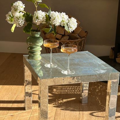 ikea disco ball table with cocktail glasses and vase on top