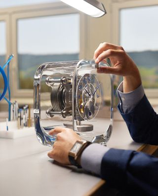 An horological engineer fine tunes the details on the Atmos 568.