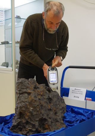 Archaeo-metallurgist Albert Jambon scans an iron meteorite with a portable X-ray fluorescence analyzer.