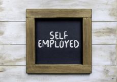 the words self employed written on a framed chalkboard