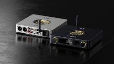 Product shot of the FiiO K13 R2R front and back in silver and black on a dark wooden surface