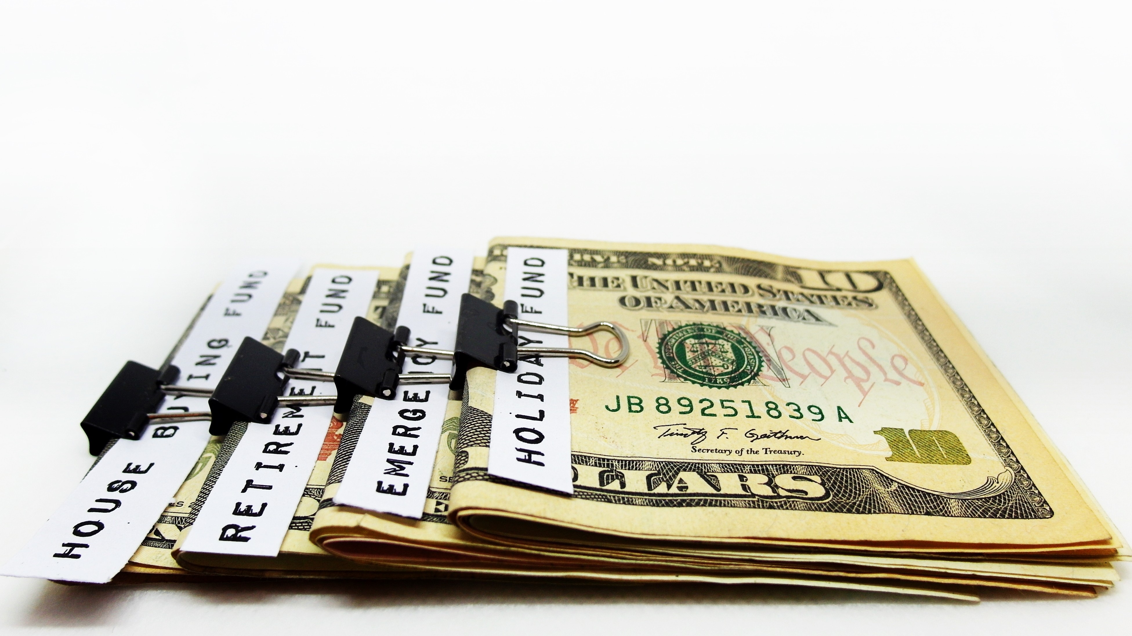 A stack of multiple bill folds, each with a different budgeting label written on them. 