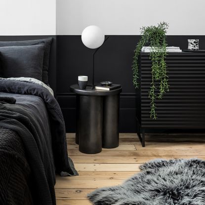 black bedroom with black paint and black bedding