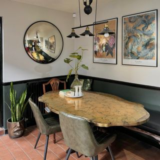 dining table and dining chairs with round mirror and artwork