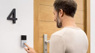 Man pressing Ring doorbell