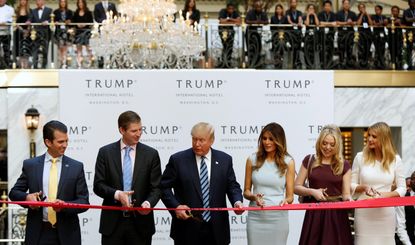 Trump and his family open the Trump International hotel in DC.