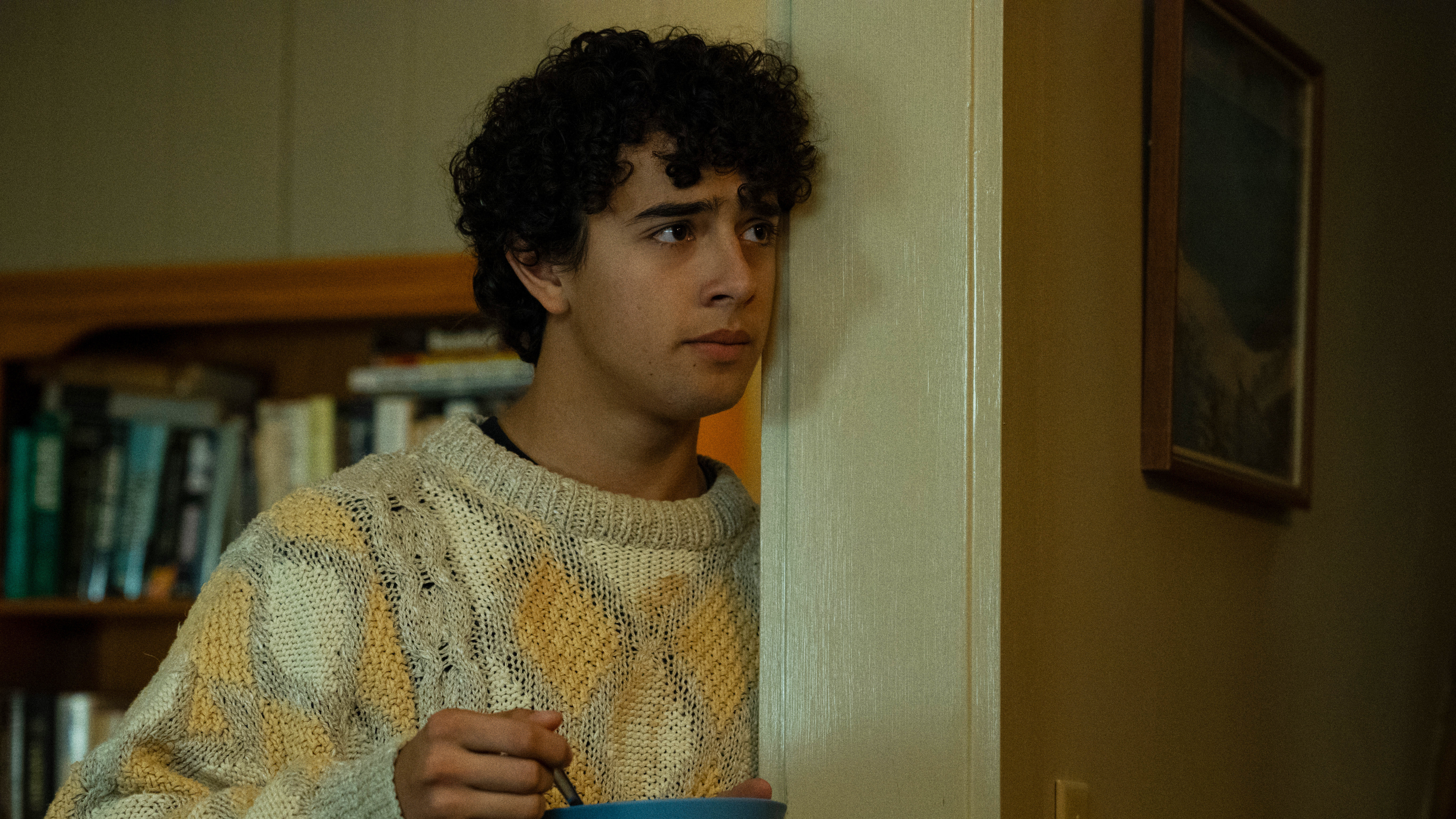 Evan leaning against a doorframe in Widow's Bay on Apple TV