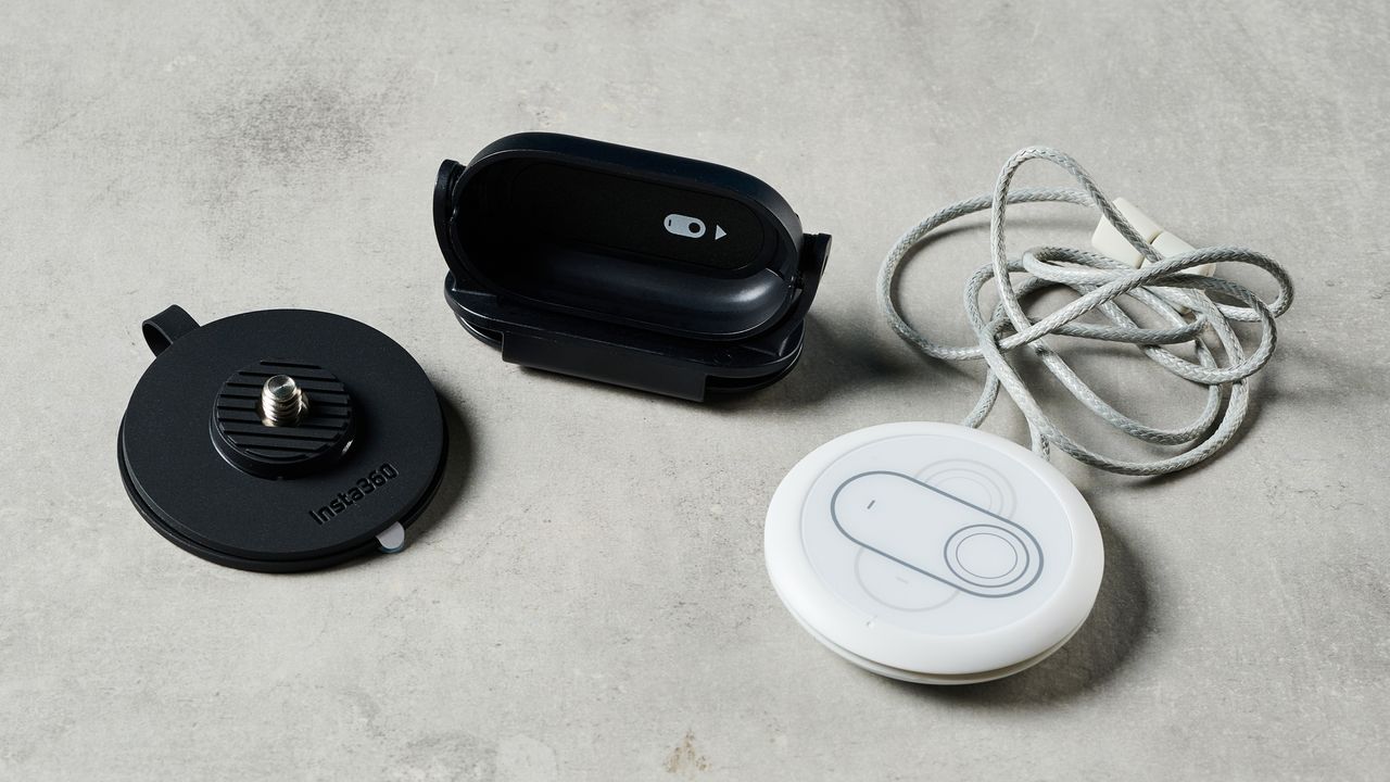 A photo of the Insta360 Go 3S with various accessories on a concrete surface.