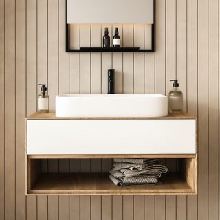 a beige bathroom with a white sink and wood floating vanity