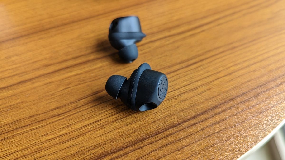 JLab Work Buds wireless earbuds with detachable microphone kept on a table.