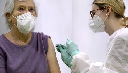 A woman receives a coronavirus vaccine.