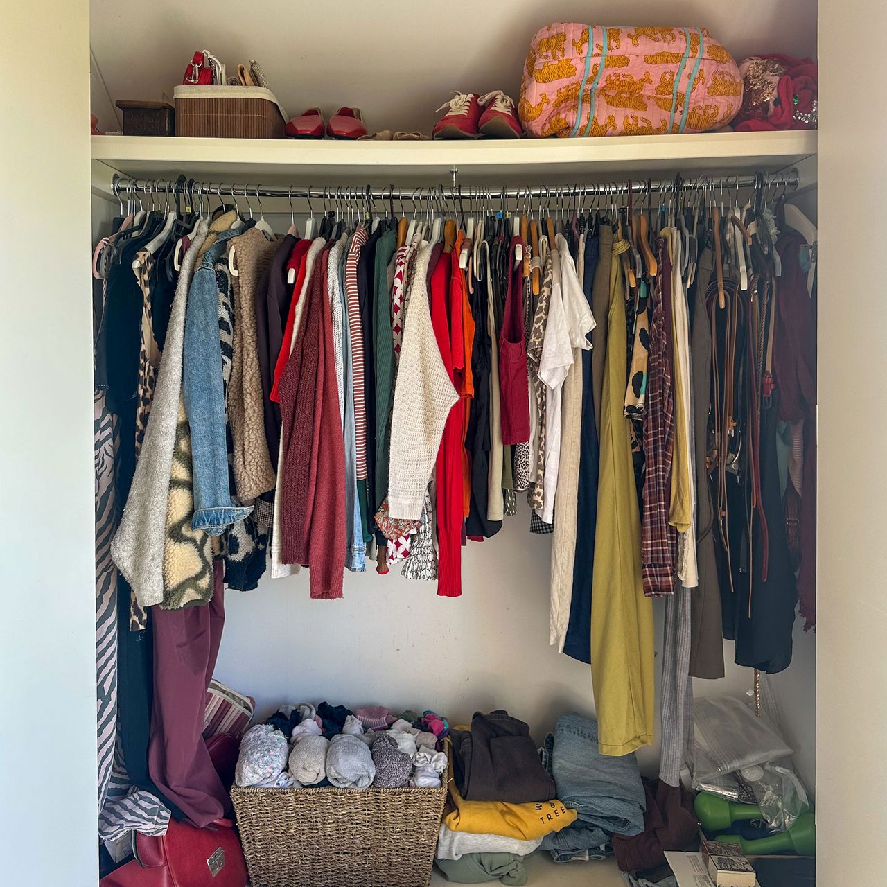 Open wardrobe filled with clothes and accessories