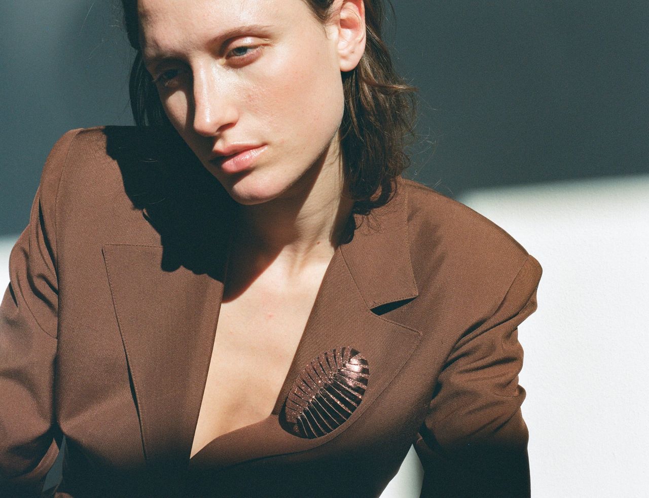 Model wears So-Le Studio leather brooch