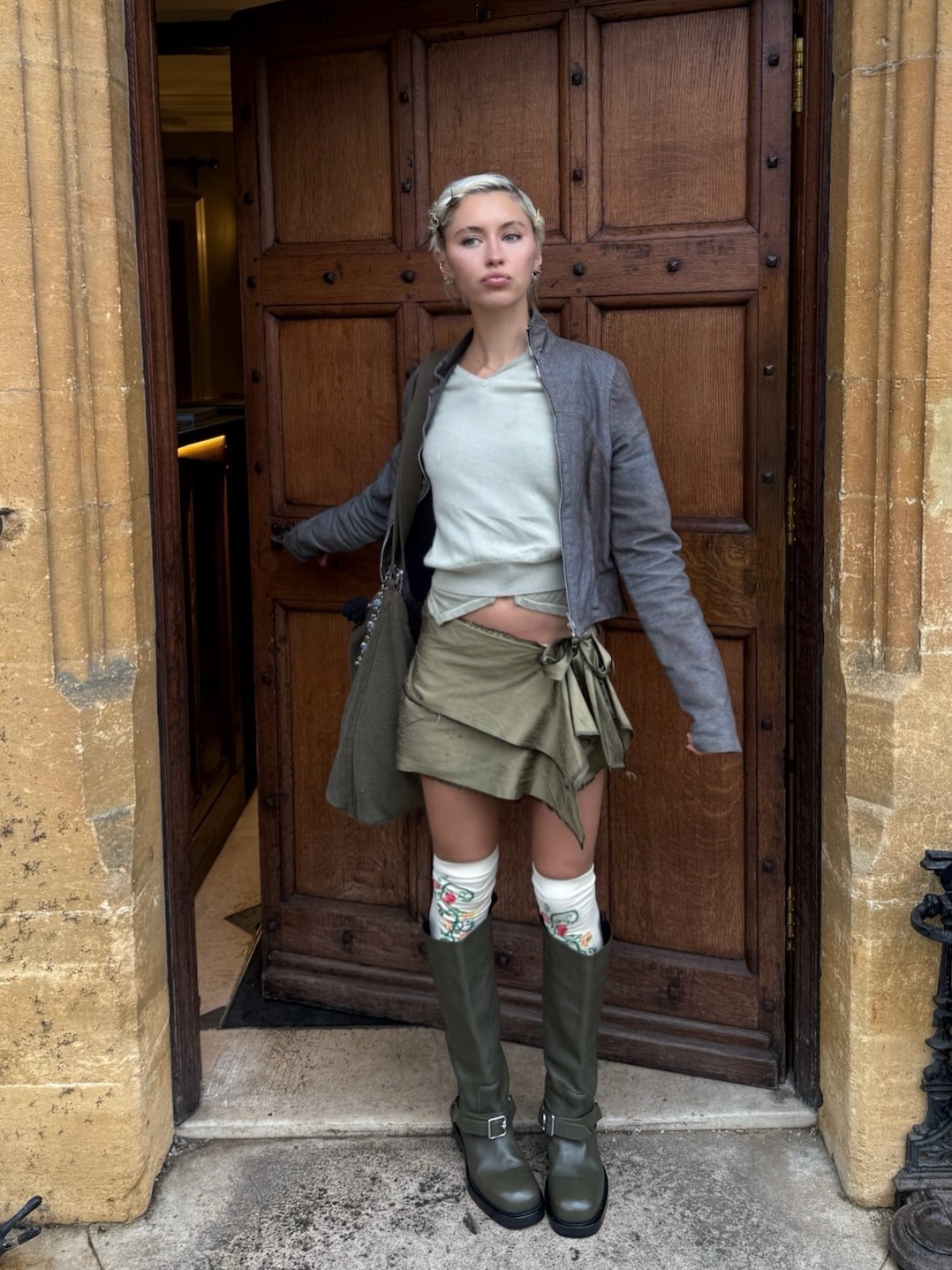 @lirisaw wearing a chic spring boot and skirt outfit