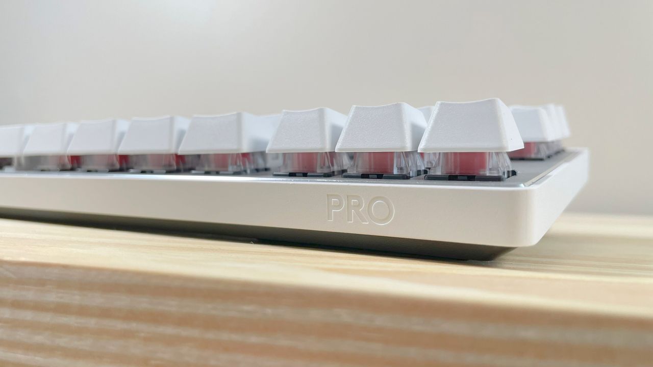 Close up of the "Pro" icon on the edge of the Logitech G PRO X TKL Rapid gaming keyboard in white