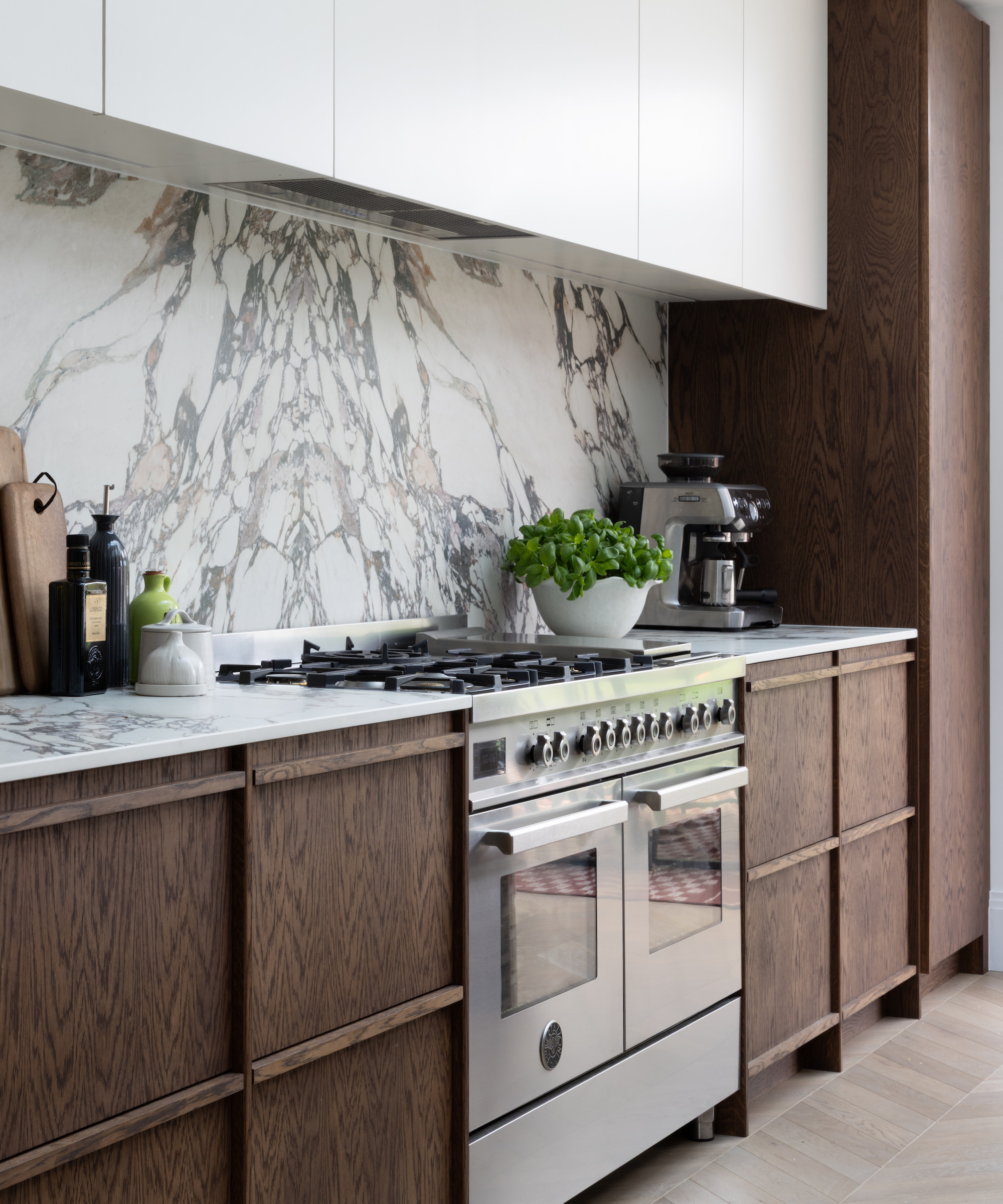 dark wood kitchen with marble look backsplash