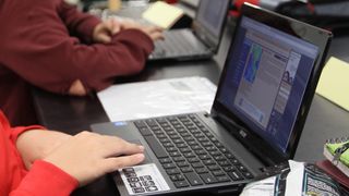 A student in class using their Chromebook