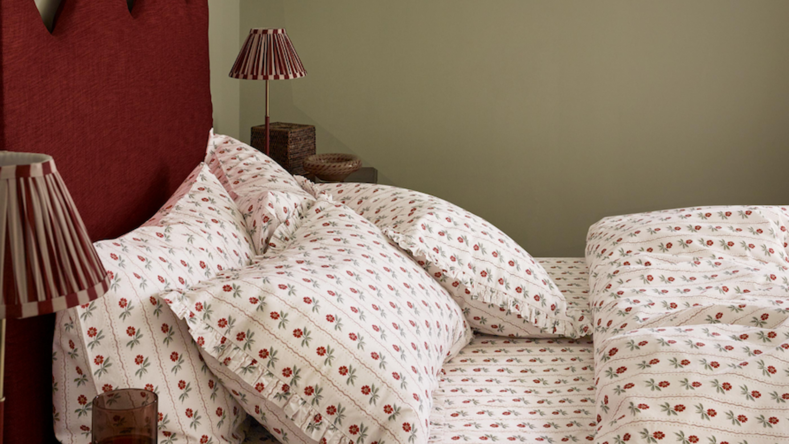 Green bedroom featuring a crimson sculptural headboard and floral cotton bed sheet set 