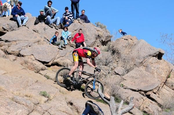 Riders descend a tricky rocky trail.