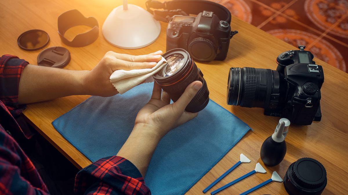 someone cleaning a lens