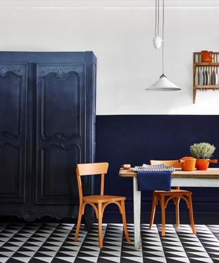 Blue traditional kitchen idea by Annie Sloan with armoire wooden table and chairs and monochrome flooring