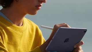 Woman using Apple Pencil with iPad 
